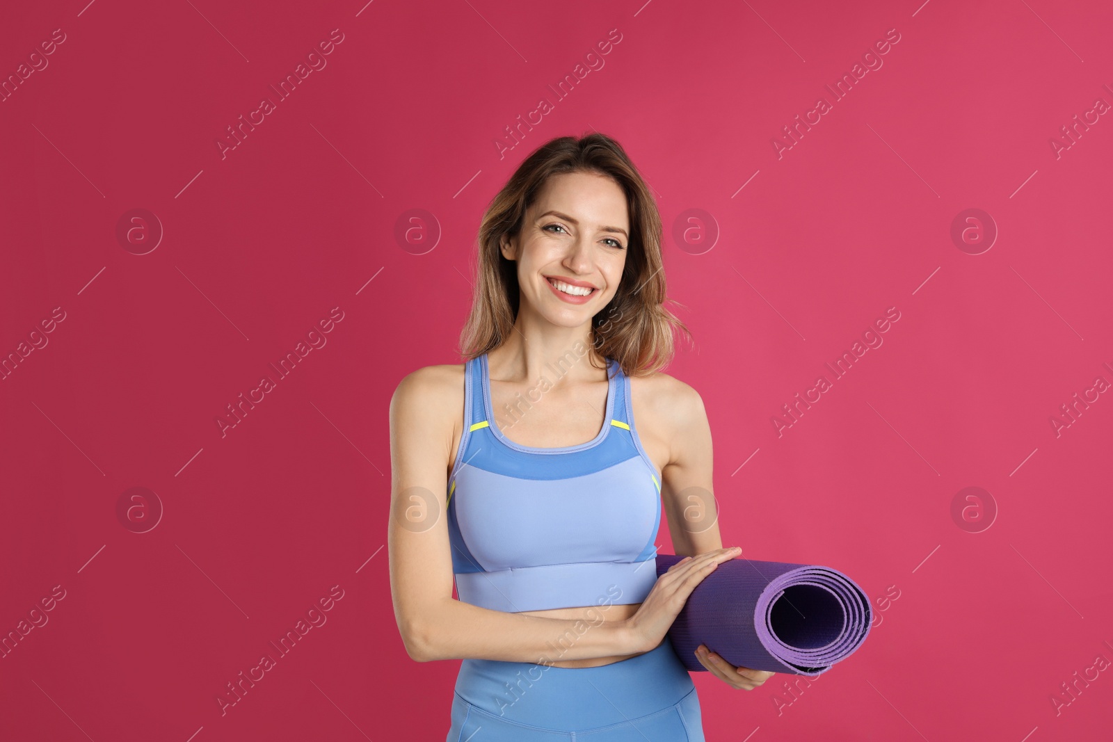 Photo of Beautiful woman with yoga mat on pink background