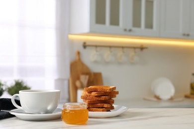 Breakfast served in kitchen. Fresh toasts, coffee and honey on white marble table. Space for text