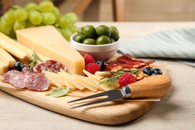 Photo of Snack set with delicious Parmesan cheese on light wooden table