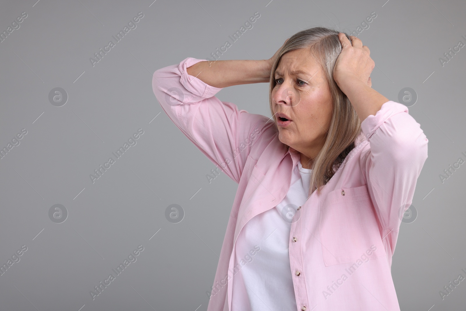 Photo of Portrait of surprised senior woman on grey background, space for text