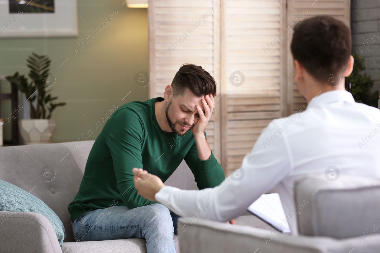 Photo of Male psychologist with client in office