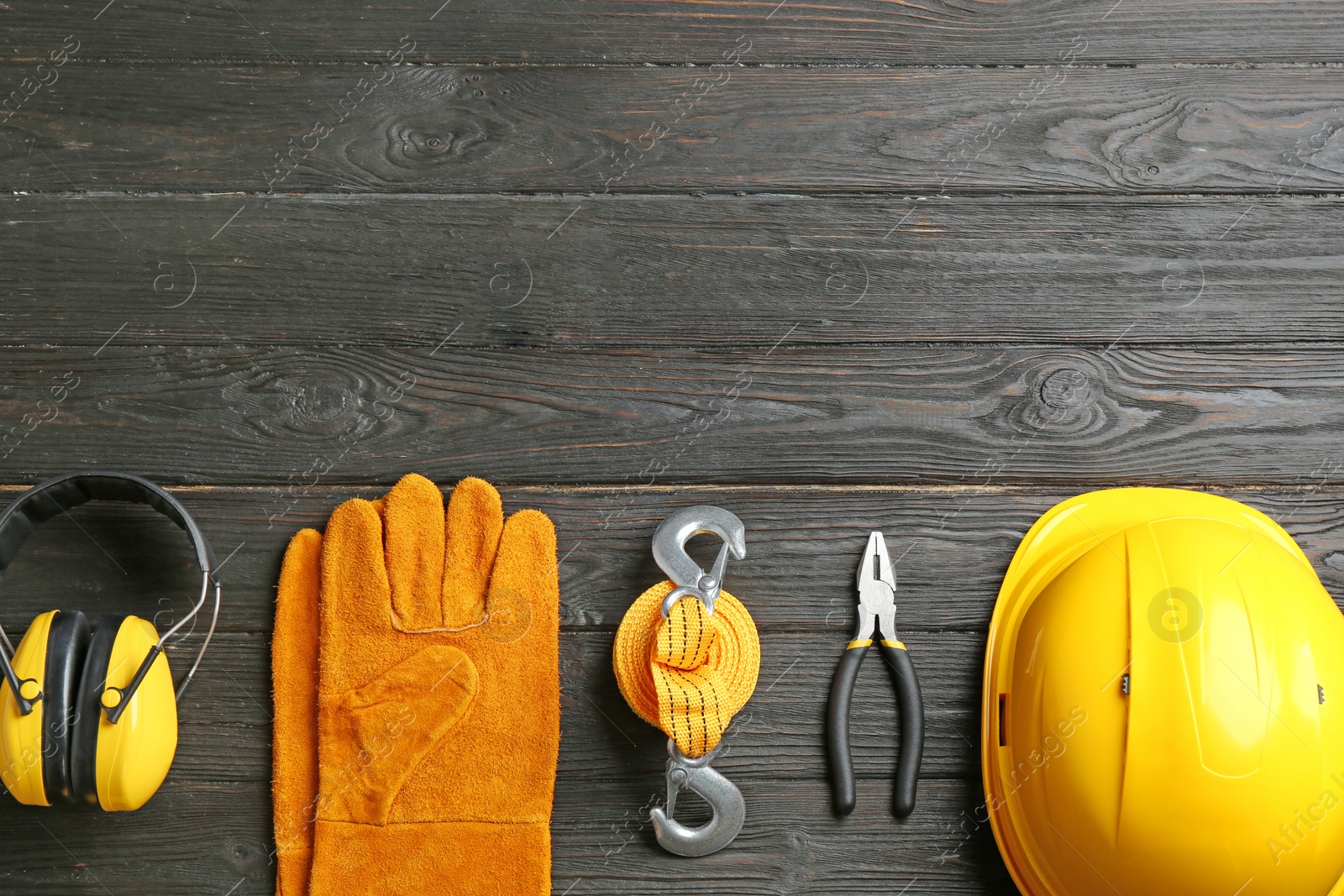 Photo of Flat lay composition with different construction tools and space for text on wooden background