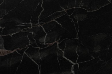 Black marble surface as background, closeup view