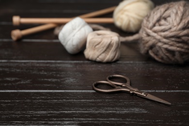 Photo of Composition with threads and knitting accessories on wooden background