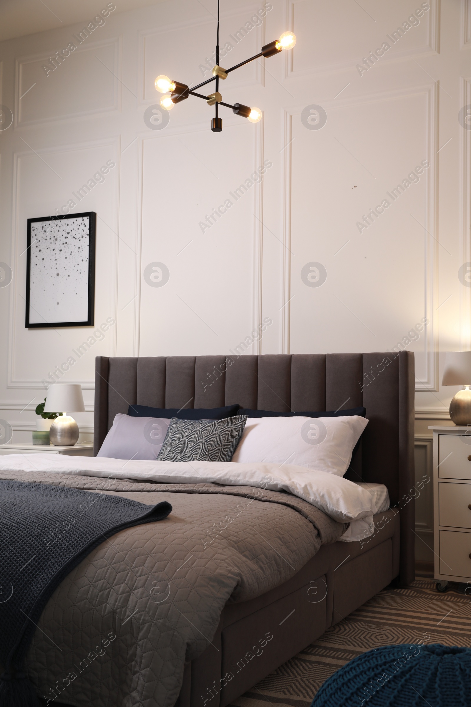 Photo of Comfortable bed with pillows and bedding in stylish room. Interior design