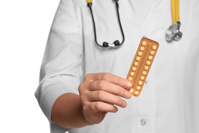 Photo of Doctor holding blister of oral contraception pills against white background, focus on hand