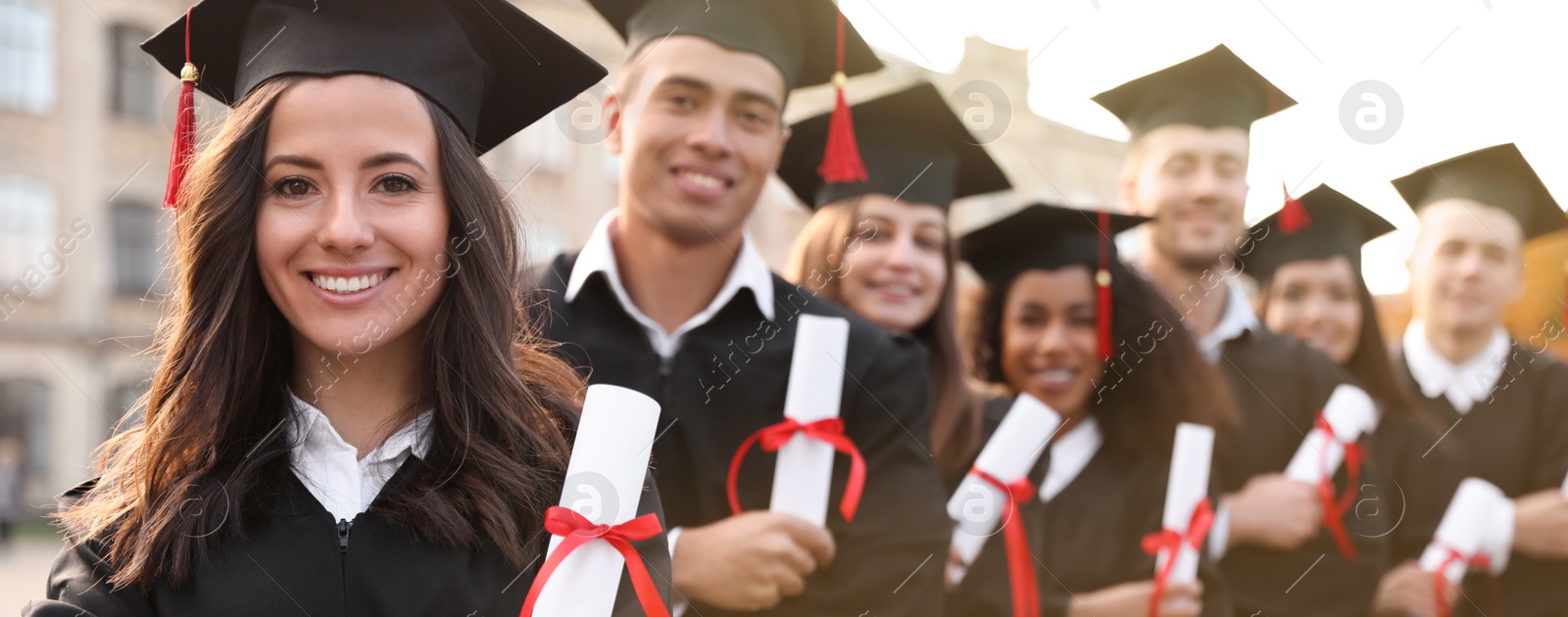 Image of Happy students with diplomas near campus. Banner design