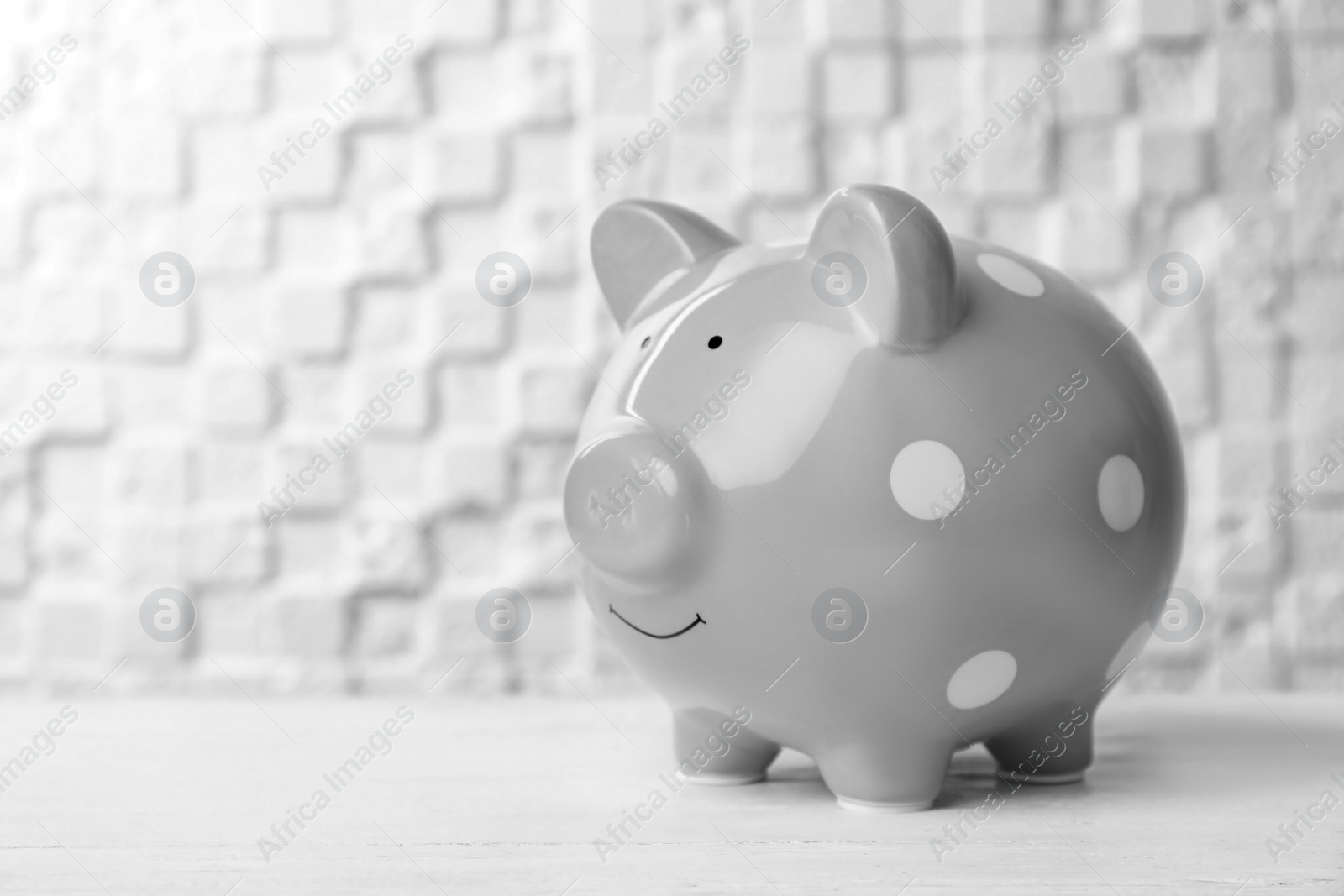 Photo of Gray piggy bank on white table. Money saving