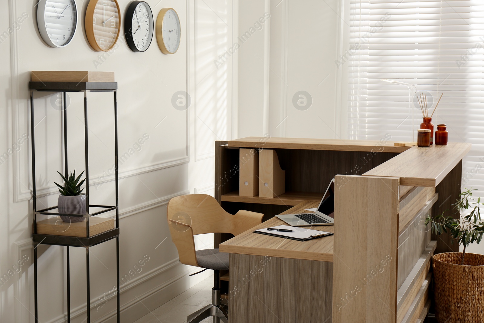 Photo of Receptionist's workplace with laptop in hotel. Interior design