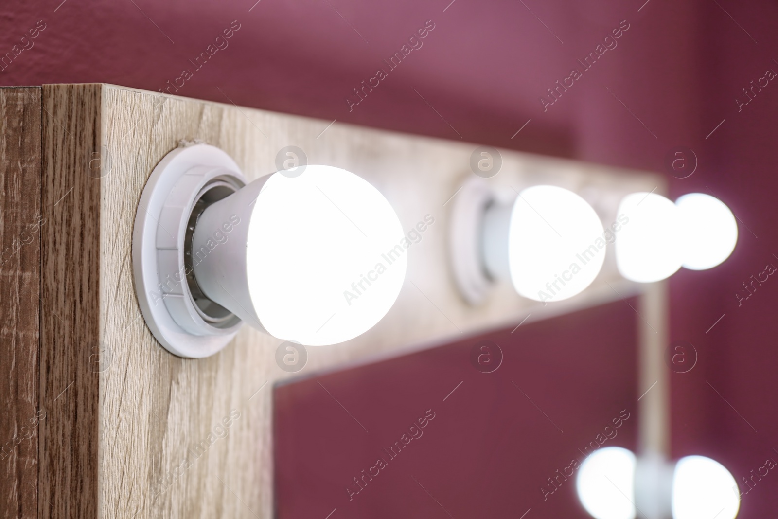 Photo of Beautiful mirror in modern makeup room, closeup