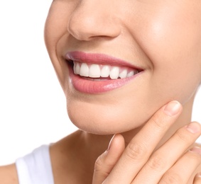 Young woman with beautiful smile on white background, closeup. Teeth whitening