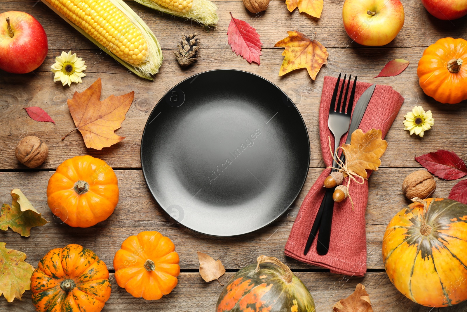 Photo of Flat lay composition with tableware, autumn fruits and vegetables on wooden background. Thanksgiving Day