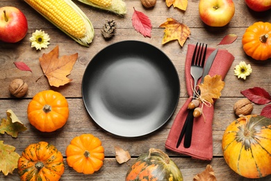 Photo of Flat lay composition with tableware, autumn fruits and vegetables on wooden background. Thanksgiving Day