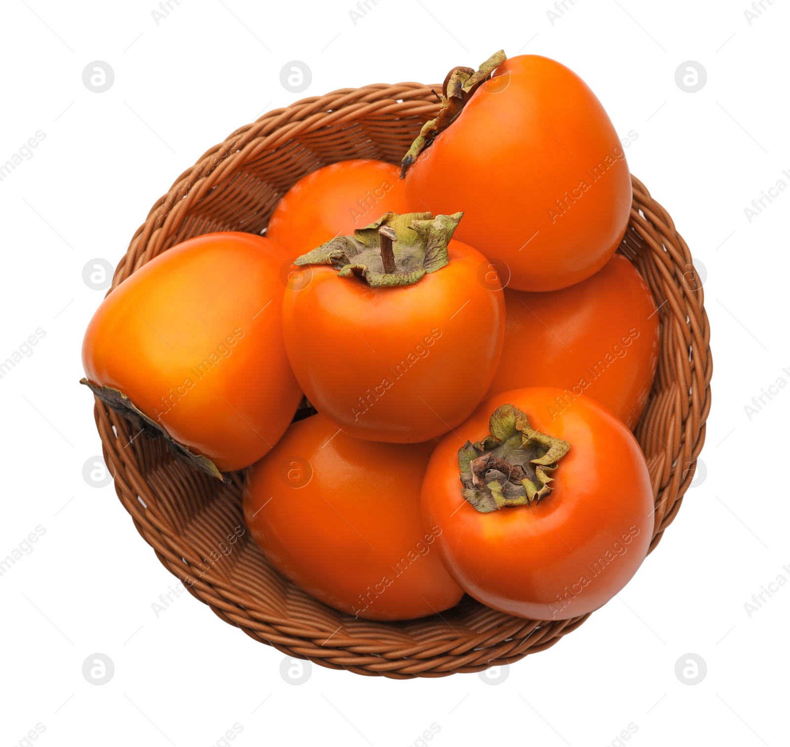 Photo of Delicious ripe persimmons in wicker basket on white background, top view