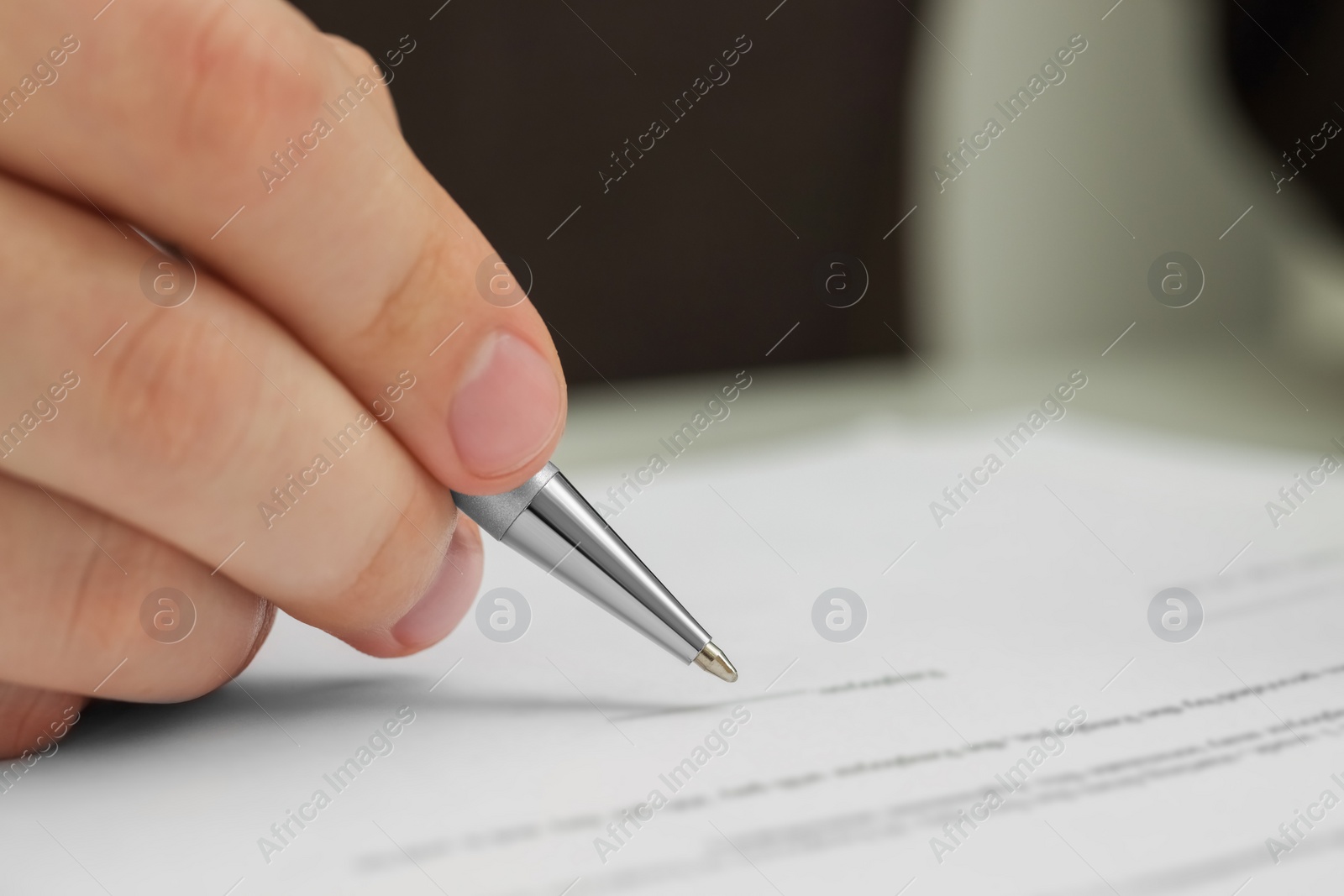 Photo of Man signing document, closeup view. Space for text