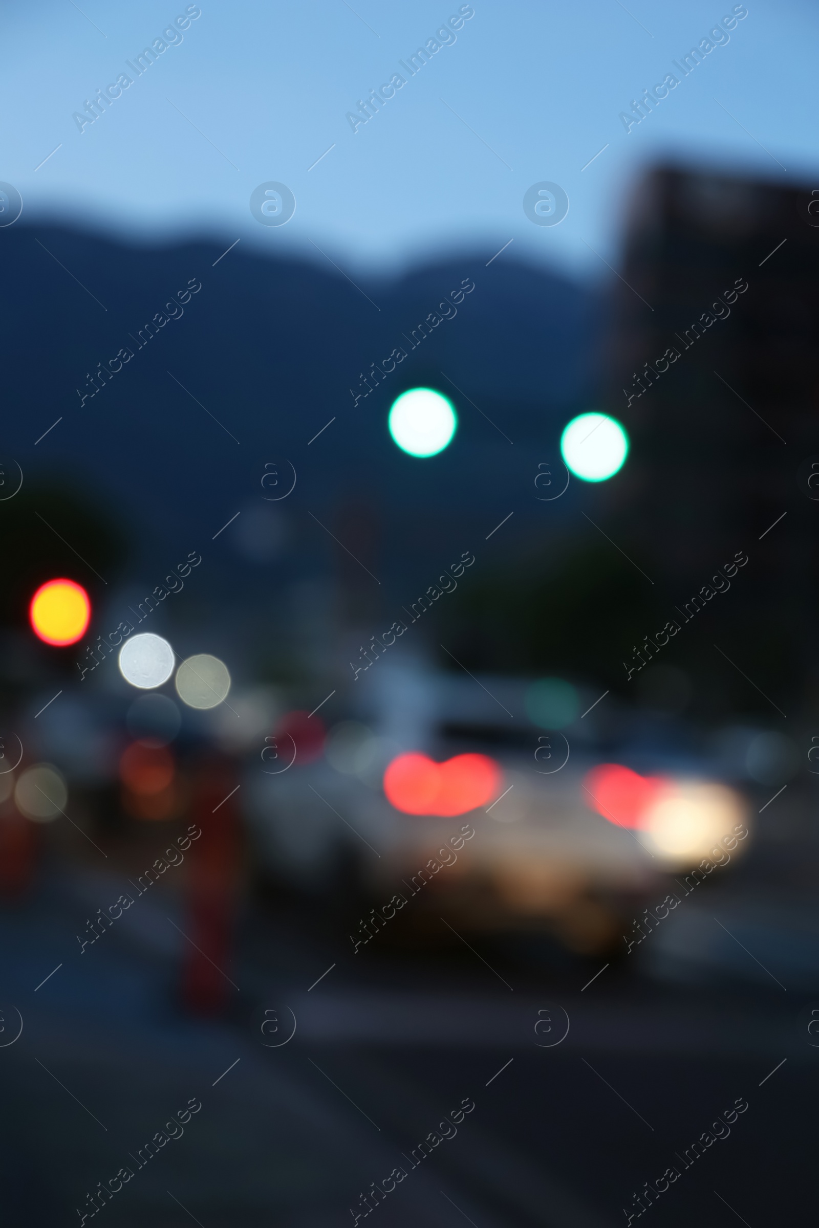 Photo of Blurred view of modern city and road with cars. Bokeh effect