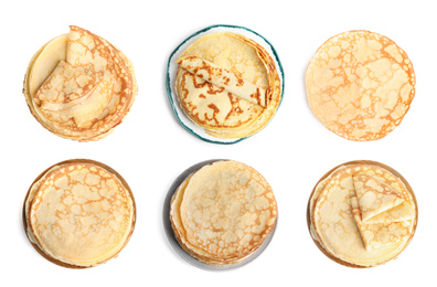 Set of delicious thin pancakes on white background, top view