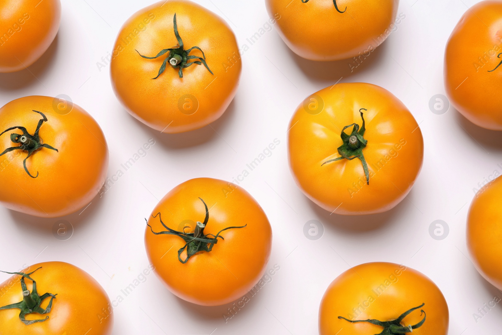 Photo of Fresh ripe yellow tomatoes on white background, top view