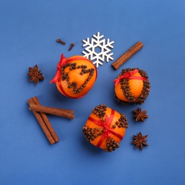 Flat lay composition with pomander balls made of fresh tangerines on blue background