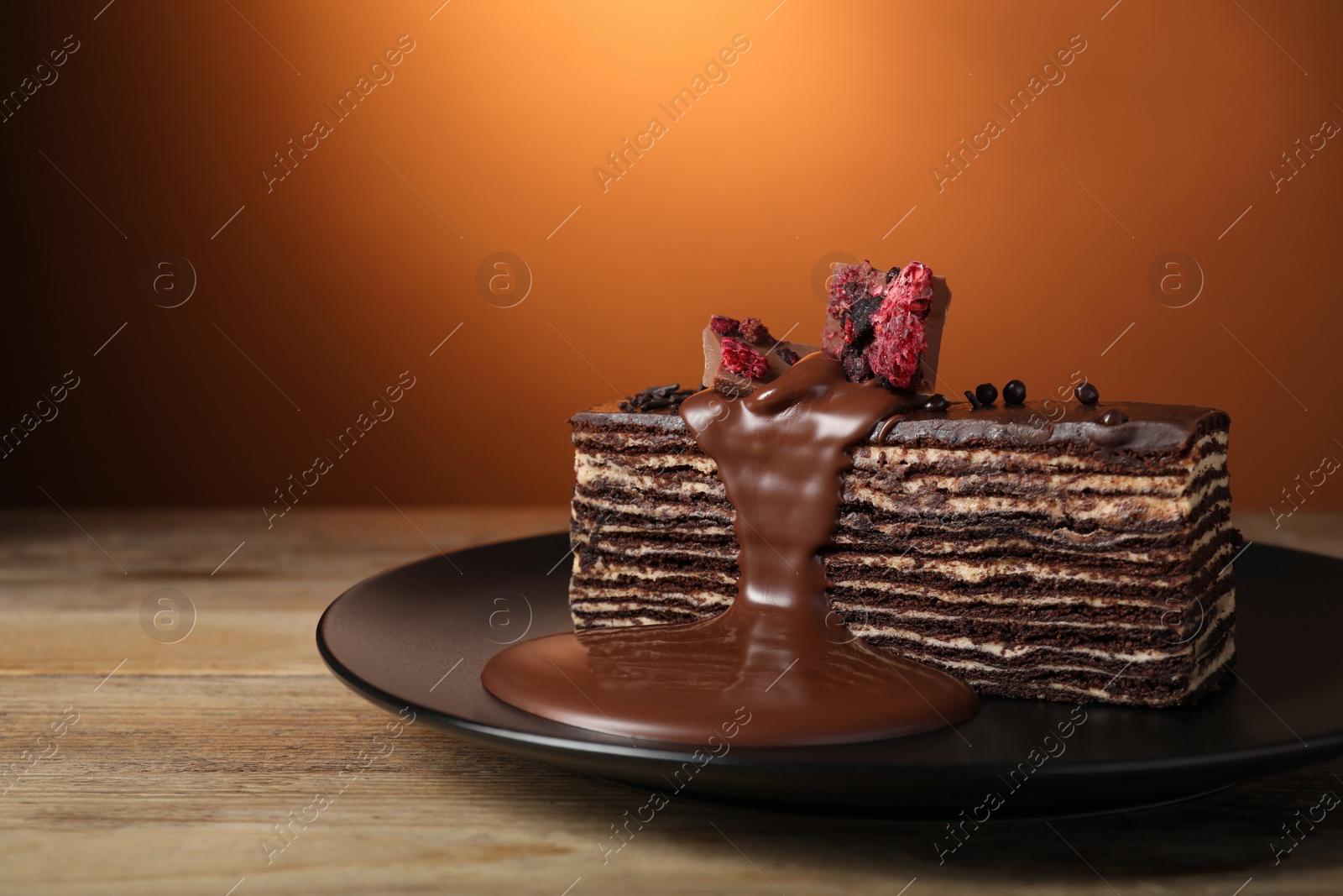 Photo of Tasty chocolate cake on wooden table, space for text