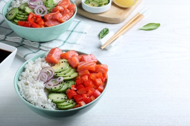 Photo of Delicious poke bowl with salmon and vegetables served on white wooden table. Space for text