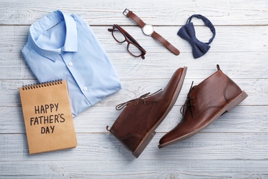Photo of Flat lay composition with shoes, shirt and accessories on wooden background. Father's day celebration