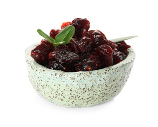 Photo of Dried cranberries and leaves in bowl isolated on white