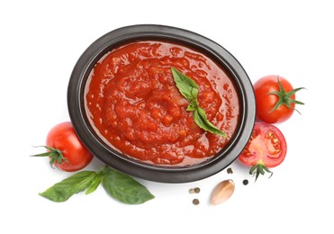 Photo of Homemade tomato sauce in bowl and fresh ingredients isolated on white, top view