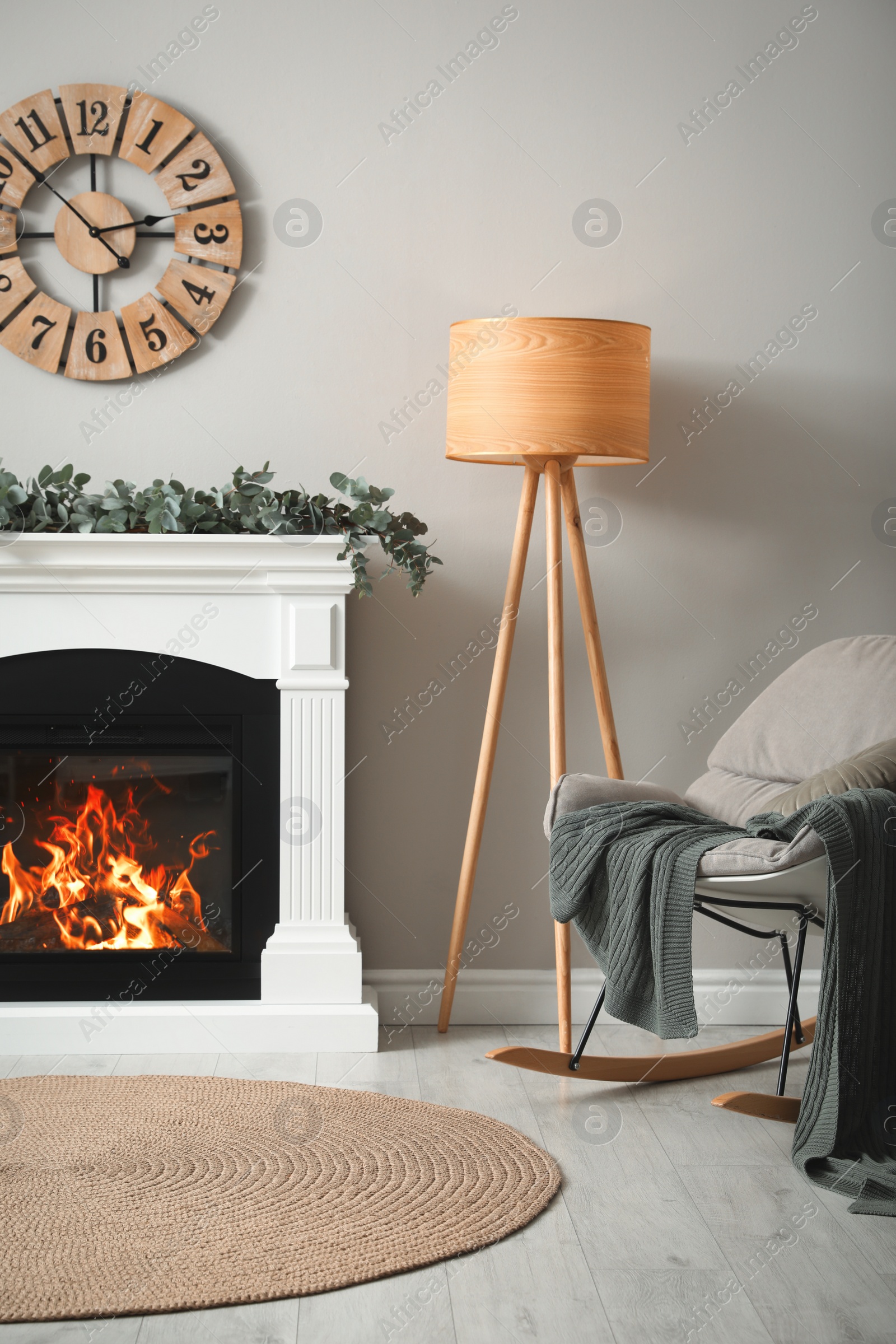 Photo of Stylish room decorated with beautiful eucalyptus garland on fireplace