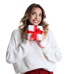 Beautiful young woman with Christmas present on white background