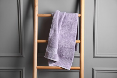 Soft terry towel on wooden ladder indoors