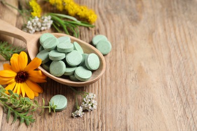 Photo of Spoon of pills, different herbs and flowers on wooden table, closeup with space for text. Dietary supplements