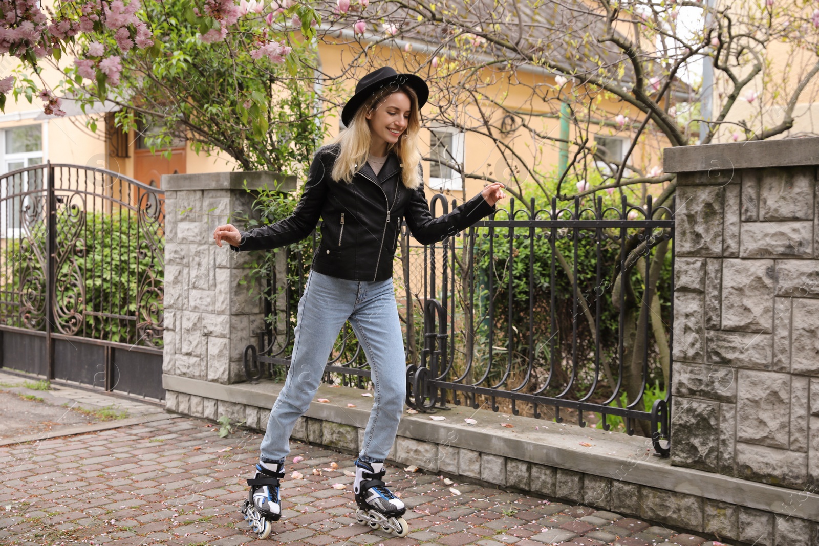 Photo of Young woman roller skating on spring day