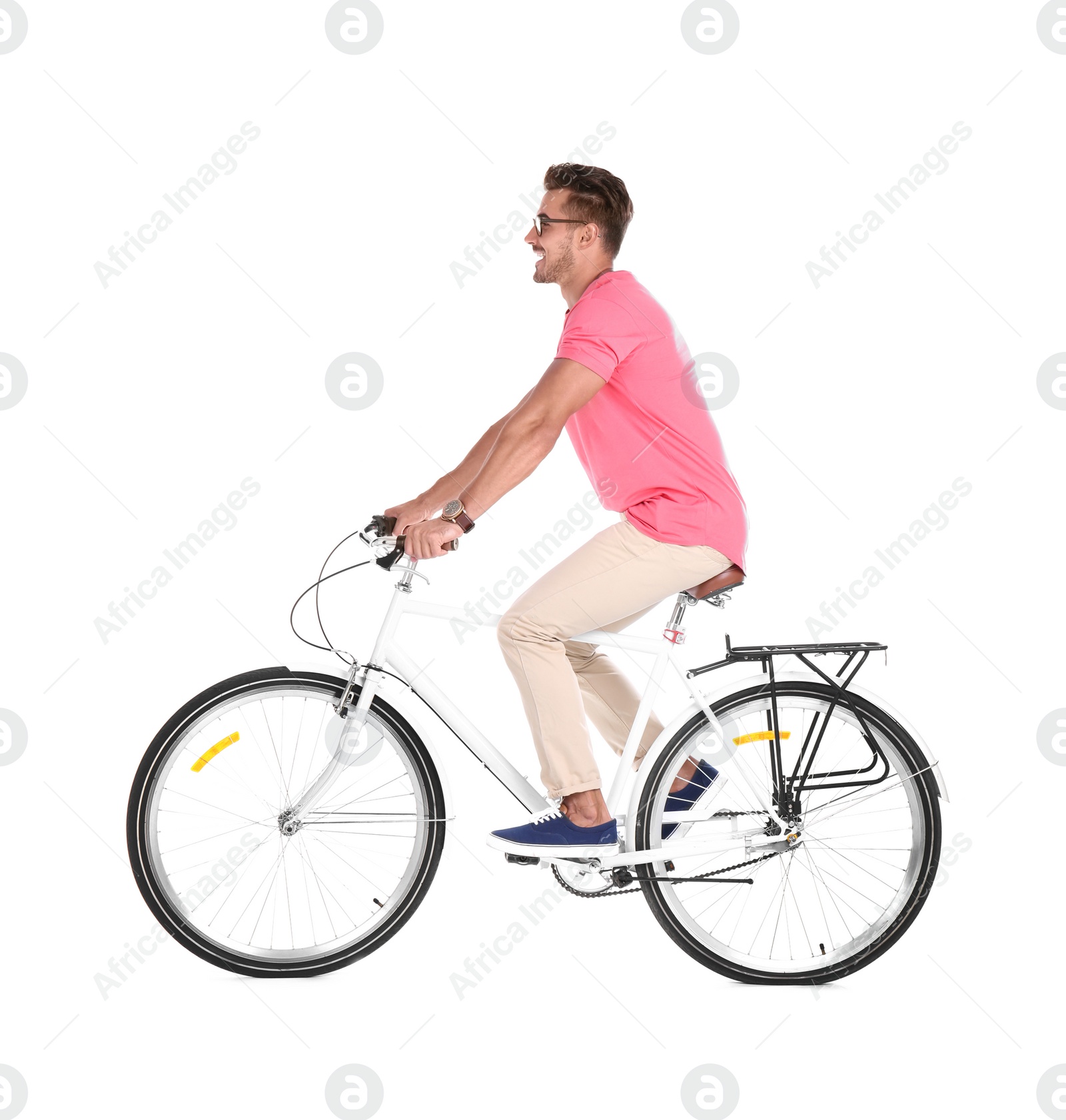 Photo of Handsome young hipster man riding bicycle on white background