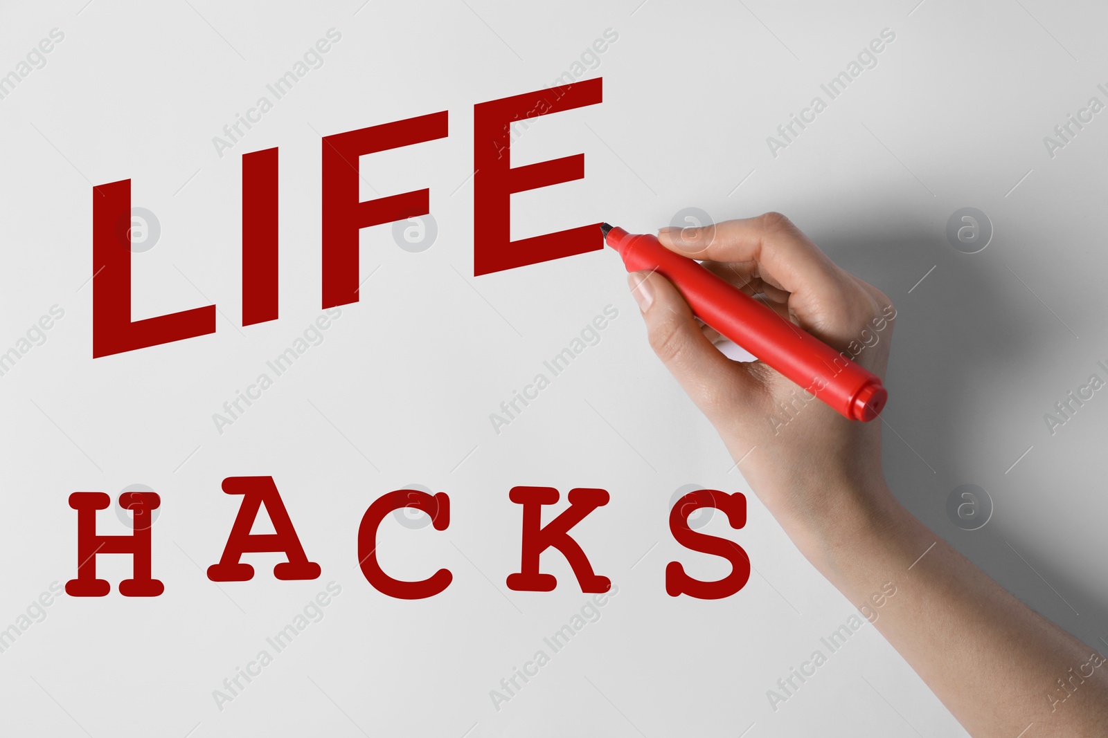 Image of Woman writing words Life Hacks on whiteboard, closeup