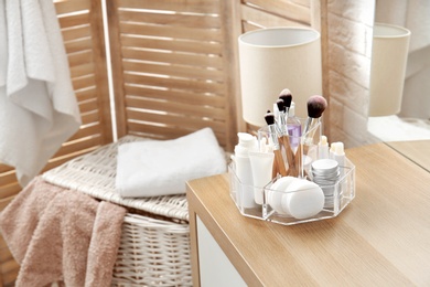 Photo of Organizer with cosmetic products and space for text on dressing table