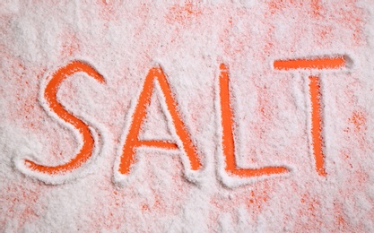 Photo of Word SALT on orange background, top view