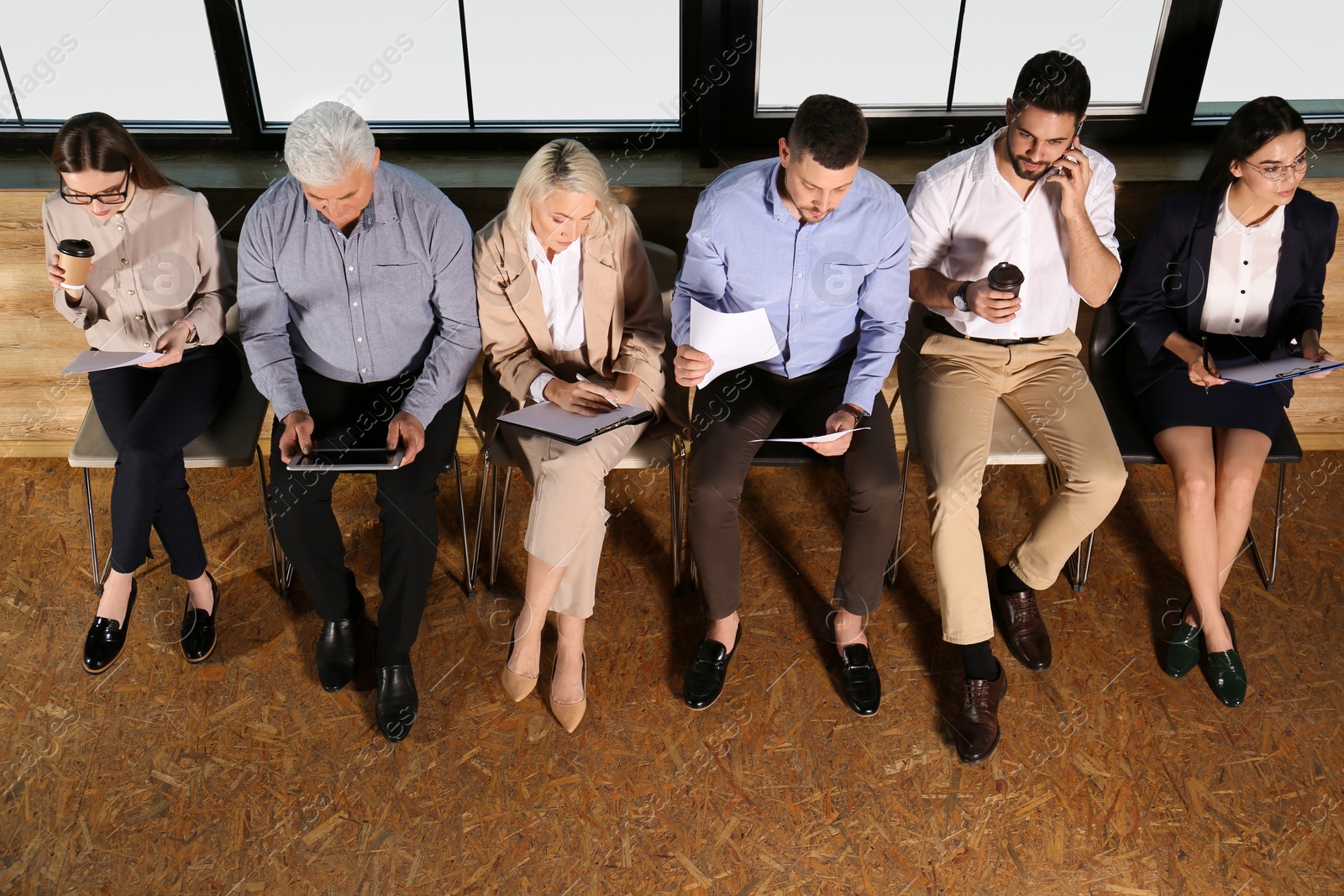 Photo of People waiting for job interview in office hall, above view