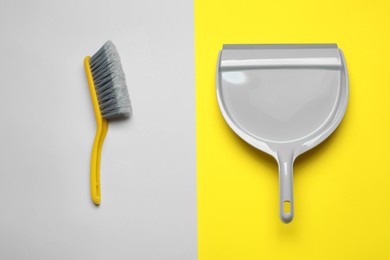 Photo of Plastic hand broom and dustpan on color background, flat lay