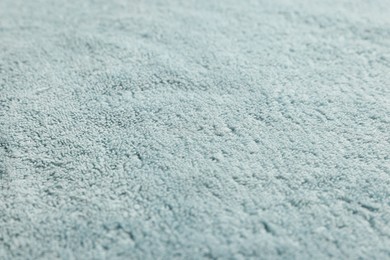 Photo of Soft light blue towel as background, closeup