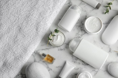 Flat lay composition with different body care products on marble background. Mockup for design