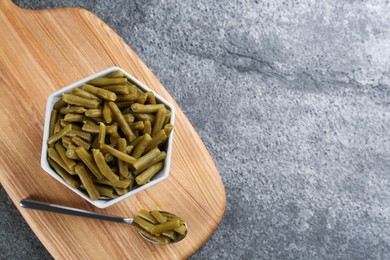 Photo of Canned green beans on grey table, top view. Space for text