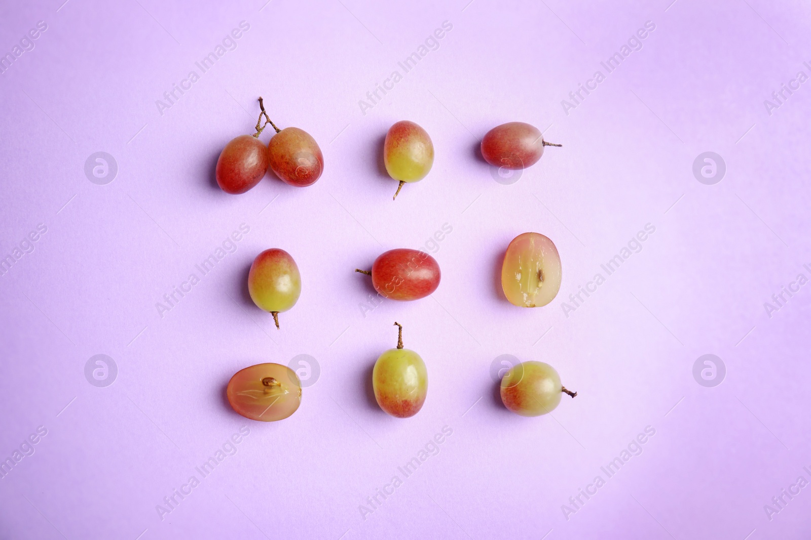 Photo of Fresh ripe juicy grapes on color background, top view