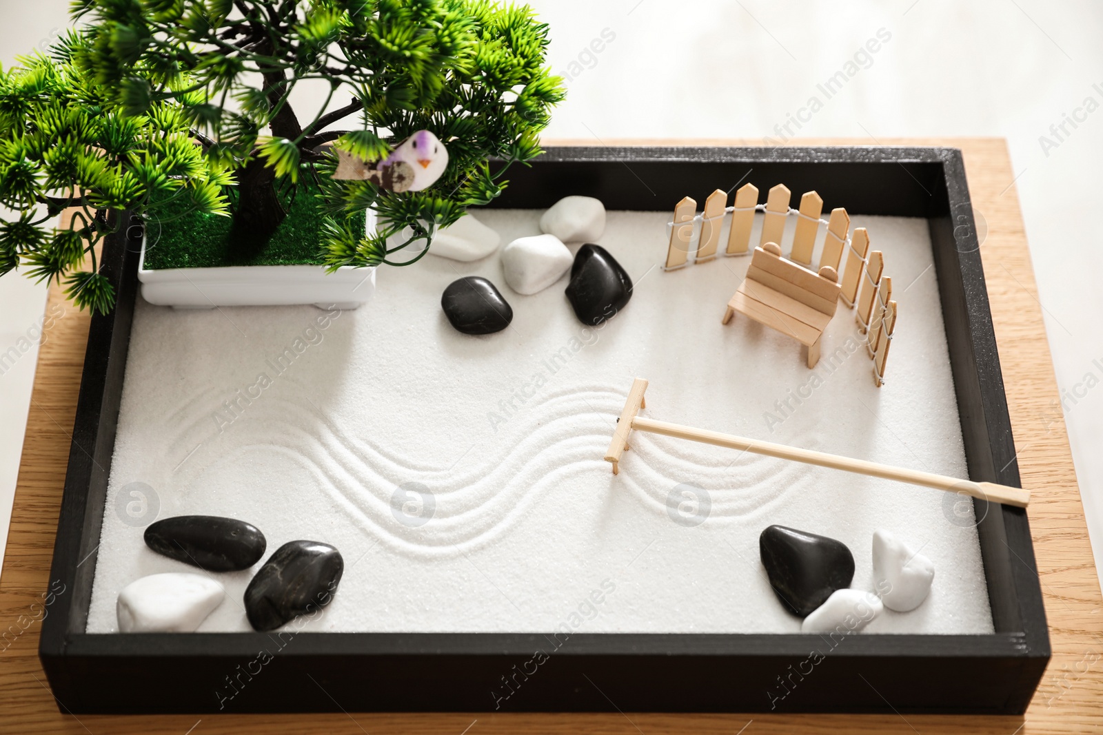 Photo of Beautiful miniature zen garden on wooden table