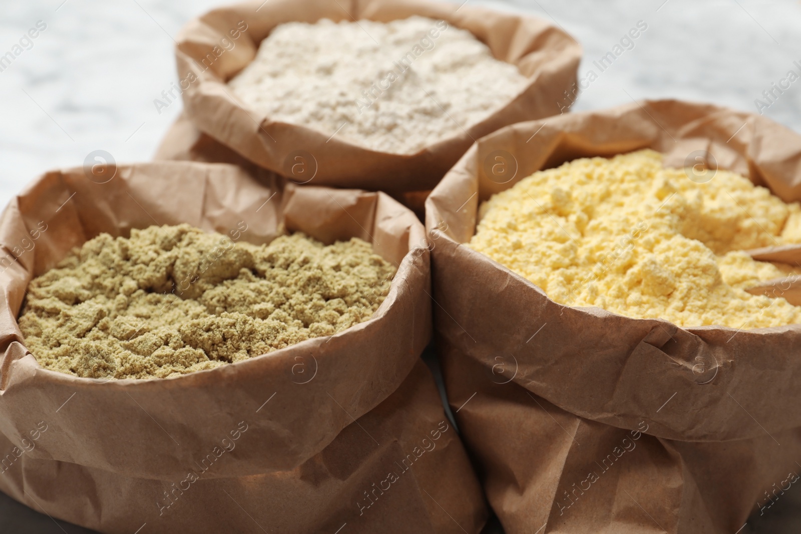 Photo of Paper bags with different types of flour, closeup