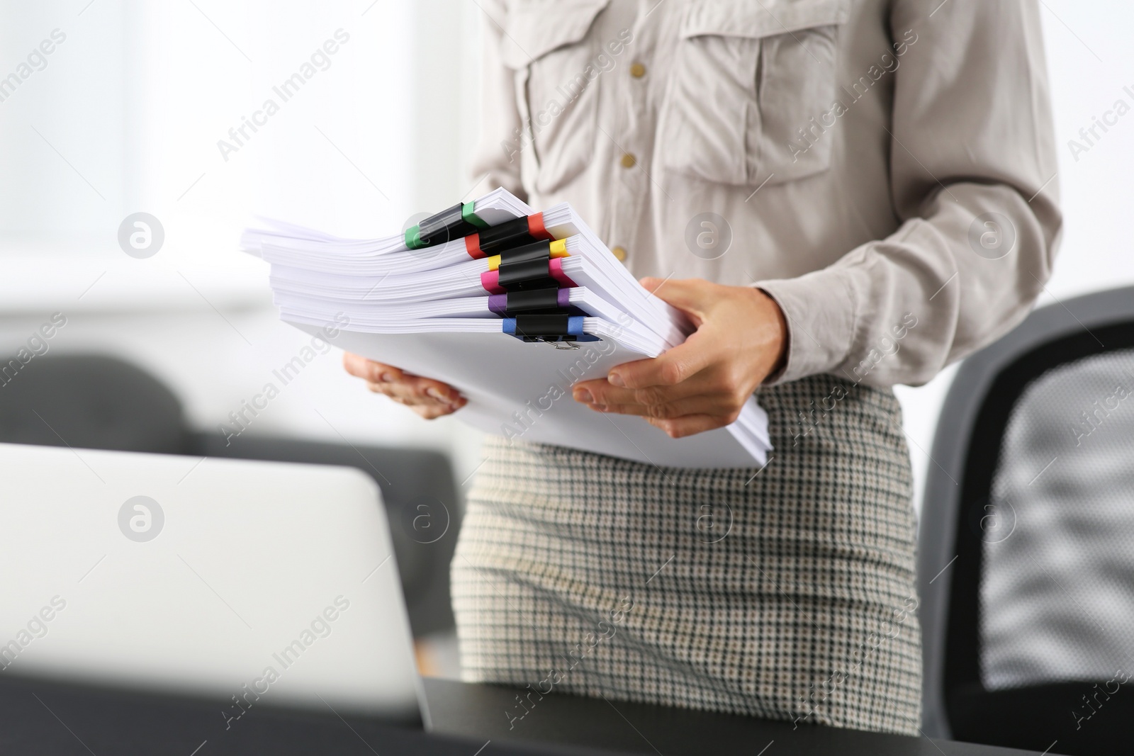 Photo of Businesswoman with documents in office, closeup. Space for text