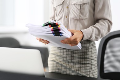 Photo of Businesswoman with documents in office, closeup. Space for text