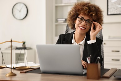 Photo of Notary using laptop at workplace in office