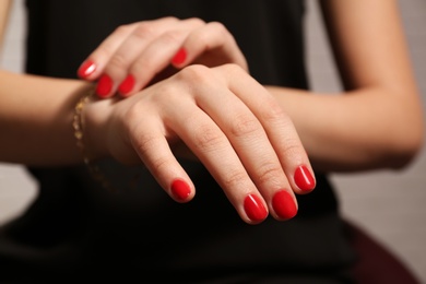 Photo of Woman with red manicure, closeup. Nail polish trends