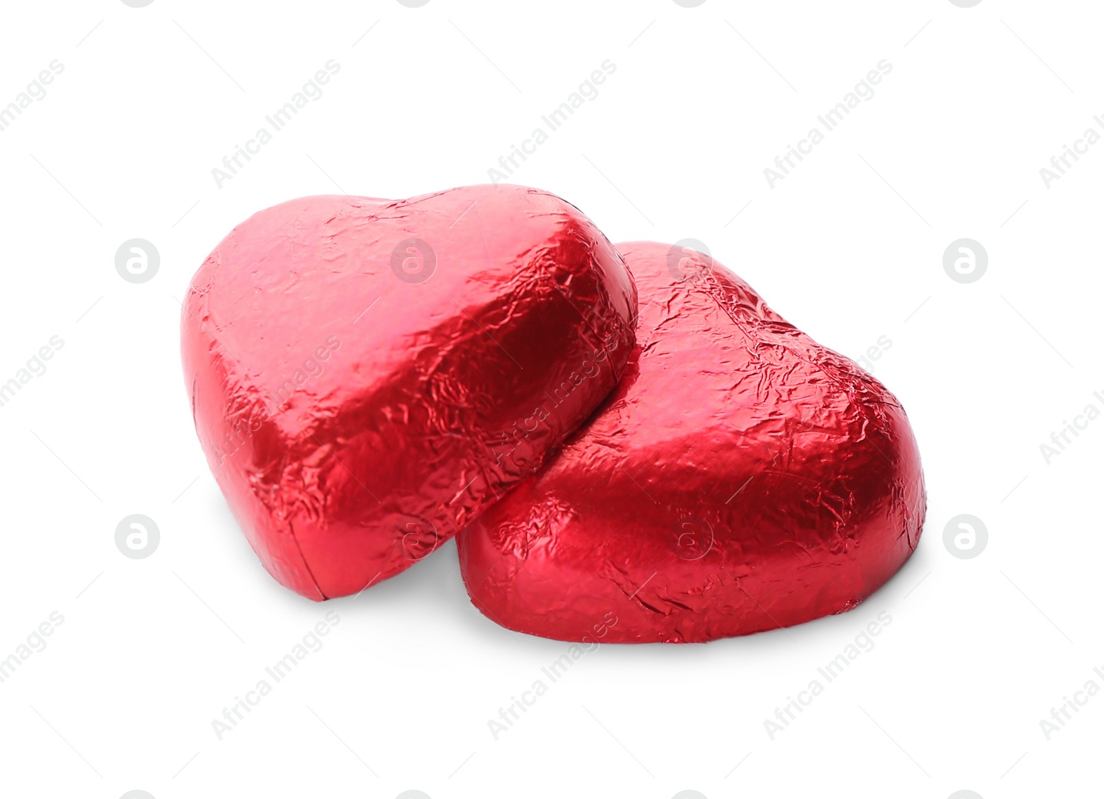 Photo of Heart shaped chocolate candies in red foil on white background